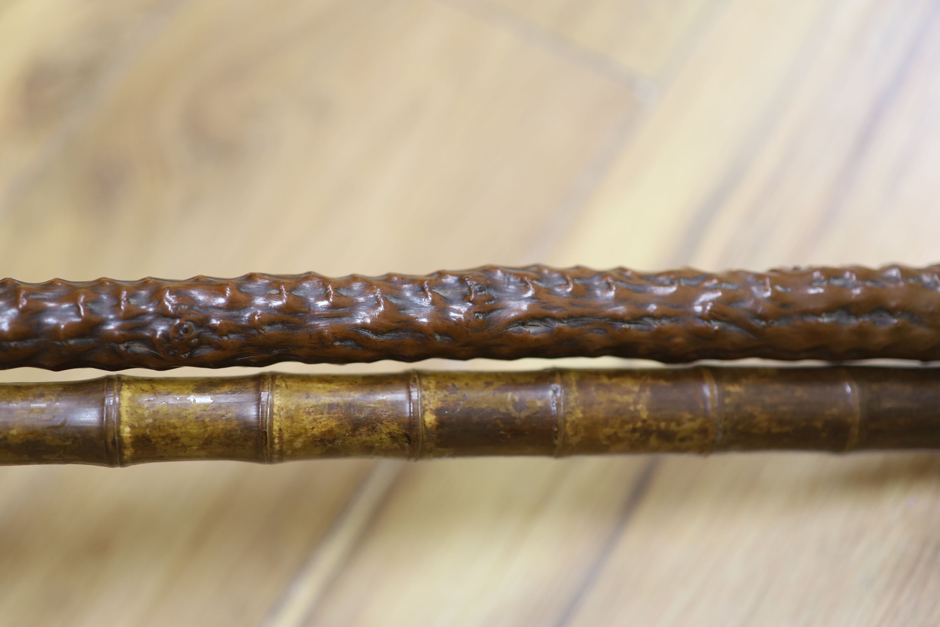 A yellow metal mounted bamboo cane and a gilt metal mounted cane